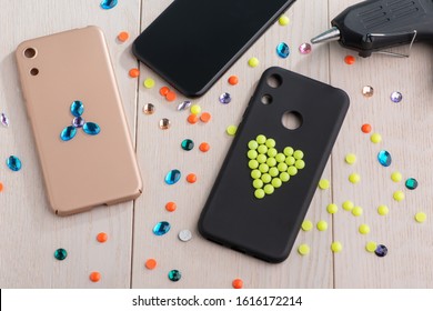 Cell Phone Cases Being Decorated With Rhinestones And Beads. Girls DIY Project, Art And Style.