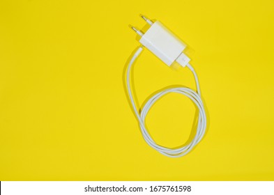 Cell Phone Charger Isolated On Yellow Background