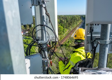 Cell Phone Installers Work On The Tower