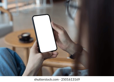 Cell phone mockup blank white screen. Woman hand holding mobile phone at coffee shop. Female hipster using smartphone, blank whire screen template for product advertising, mobile app design - Powered by Shutterstock