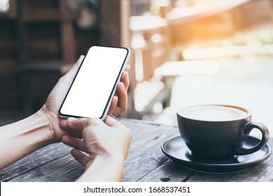 Cell Phone Mockup Image Blank White Screen.woman Hand Holding Texting Using Mobile On Desk At Coffee Shop.background Empty Space For Advertise Text.people Contact Marketing Business,technology 