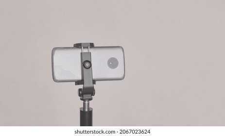 Cell Phone Mounted On A Cell Phone Tripod, On White Background.