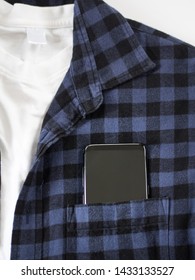 Cell Phone In Pocket Of Navy Blue And Black Scotch Shirt