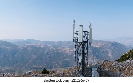 Cell Phone Tower. Cellular Antenna, 5G Radio Network Telecom Transmitter Aerial View. Rocky Mountain And Sky Background