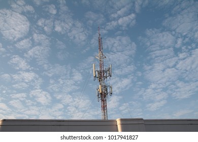 Cell Site Mobile Telephone On Rooftop Building Blue Sky White Clouds