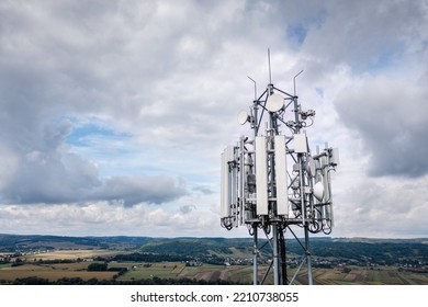 Cell Tower Carrying Antennas Of Cellular Networks GSM Transmitter Receiver Against Cloudy Sky And Landscape, Aerial Shot. Dynów, September 2022.