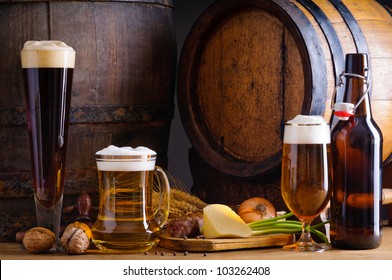 Cellar still life with beer, traditional food and barrels