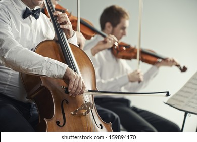 Cellist And Violinist Playing At The Concert