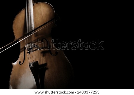 Cello with bow close up. Violoncello orchestra musical instruments closeup isolated on black background