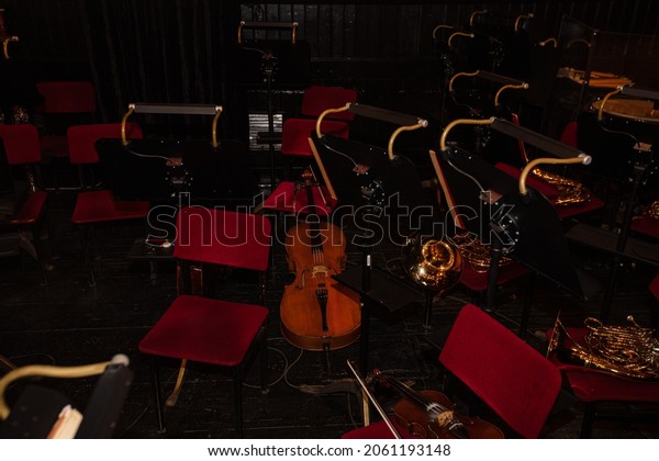 Cello and  French Horn on chair during interval \
in theatre