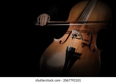 Cello player. Cellist hands playing cello with bow strings musical instrument closeup. Violoncello