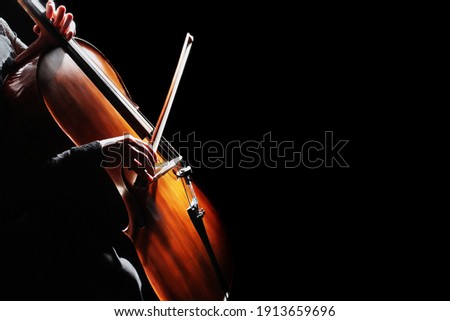 Cello player. Cellist hands playing cello orchestra instrument closeup. Violoncello
