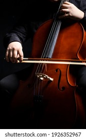Cello player or cellist performing