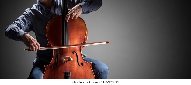 Cello Player Or Cellist Performing In An Orchestra Background Isolated With Copy Space