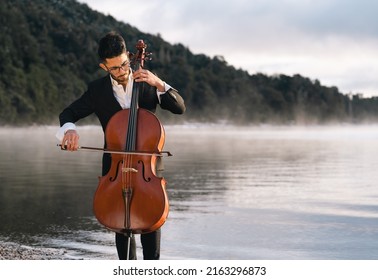 Cello Player Performing Outdoors At Sunrise