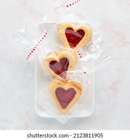 Cellophane Wrapped Raspberry Filled Linzer Cookies For Valentine's Day.