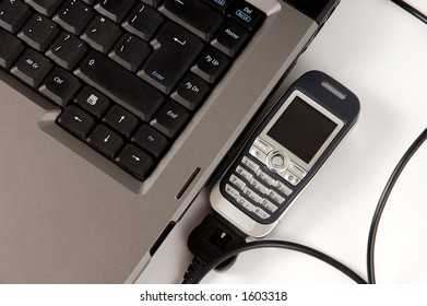 Cellphone connected to laptop computer wireless internet connection concept