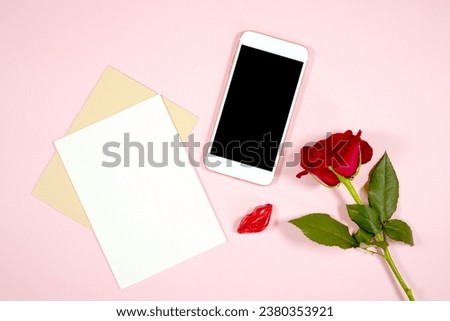 Cellphone mobile phone eVite eCard and 5x7 greeting card mockup. Valentine's day wedding love theme styled with a single red rose and lipstick chocolate against a pale blush pink background.