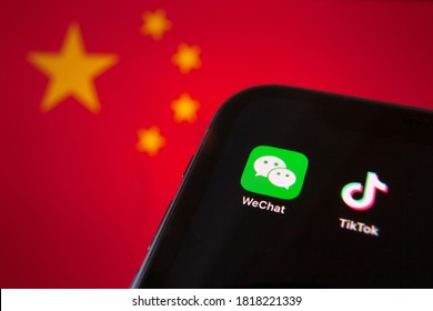 Cellphone with WeChat and TikTok icons in front of the flag of China. USA president Donald Trump bans apps of China due to the national security 