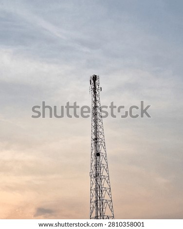 ​High cellular network tower or antenna with warm evening sky background