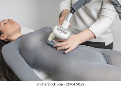 Cellulite and localised fat removal treatment on the abdomen, for younger and smoother skin. Woman receiving anti-ageing therapy with the LPG machine in a beauty salon. - Shutterstock ID 2140474129