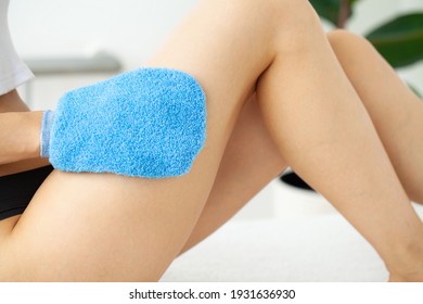 Cellulite treatment, woman arm holding dry brush to of her leg. - Powered by Shutterstock