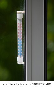 A Celsius Thermometer On A Window Frame Shows High Temperatures Of 32 Degrees During An Heat Outside Close-up.