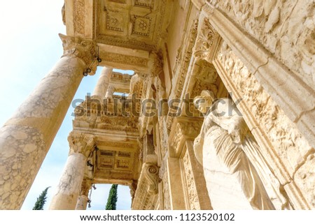 Celsus library and sculpture in Ephesus ancient city ruins on cloudy sky in Izmir, Turkey.