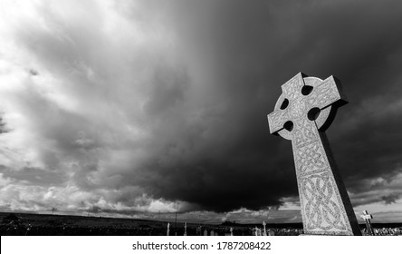 Celtic Cross against a dramatic sky in the South of Ireland (black & white version).