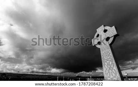 Celtic Cross against a dramatic sky in the South of Ireland (black & white version).