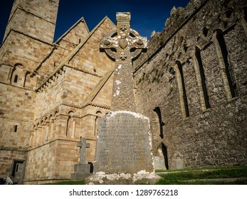 Celtic Cross With Cormac's Chapel In Rock Of Cashel Ireland