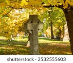 Celtic cross granite monument in the 1849 protestant Mount Hermon Cemetery seen during a golden hour fall afternoon, Quebec City, Quebec, Canada