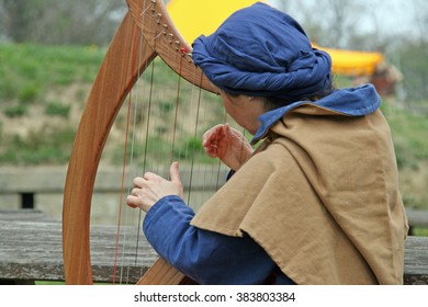 A Celtic Harp Player During A Medieval Fair In Italy