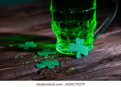 Celtic party. A lucky trilstnik with a glass of green beer in the bar for the holiday St. Patrick's Day. - Powered by Shutterstock