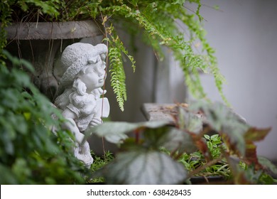 Cement baby girl doll in the mysterious garden - Powered by Shutterstock