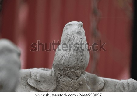 Cement bird decoration in a yard
