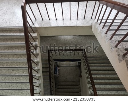Cement or concrete stairs steps  with wooden handle and day light, high angle shot.