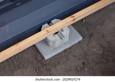 A Cement Deck Block Foundation Installed On The Ground