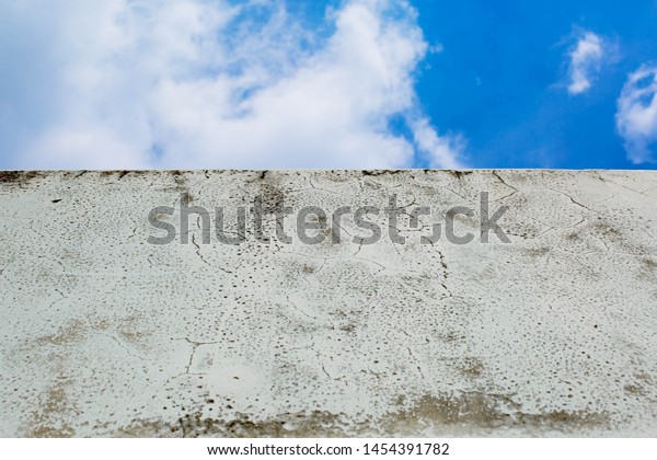 Cement\
floor and wall Of the top floor parking lot as an outdoor deck That\
is old is a background with a pattern of mold And the walls of the\
plaster have old mold stains Abstract\
pattern.