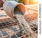 A cement mixer pouring fresh concrete onto a rebar-reinforced surface