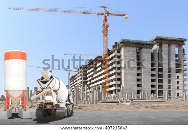 Cement mixer truck with precast concrete\
piles at building under\
construction