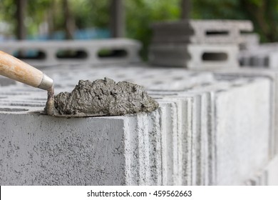 Cement or mortar, Cement mix with a trowel put on the brick for construction work. 
