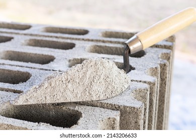 Cement or mortar, Cement powder with a trowel put on the brick for construction work.