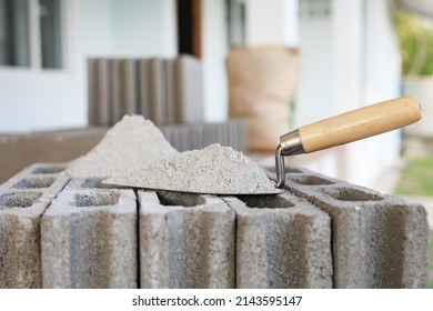 Cement or mortar, Cement powder with a trowel put on the brick for construction work.