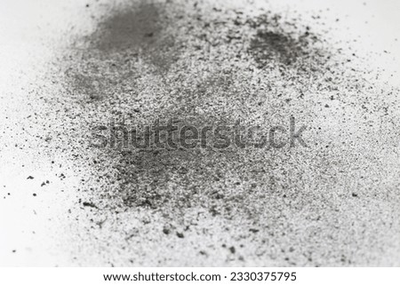 Cement on a white background. Cigarette ash is like cement, a lot of dust. Sprinkled gray dust on a white background. Gray material, very thin