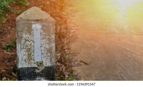 The cement pillars tell the boundaries of the grass in the background. - Shutterstock ID 1196391547