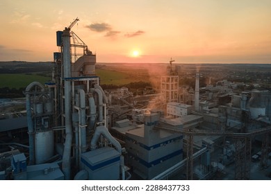 Cement plant with high factory structure and tower cranes at industrial production area. Manufacture and global industry concept - Shutterstock ID 2288437733