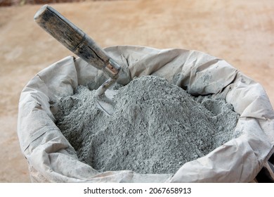 Cement powder and trowel put in bag package - Shutterstock ID 2067658913