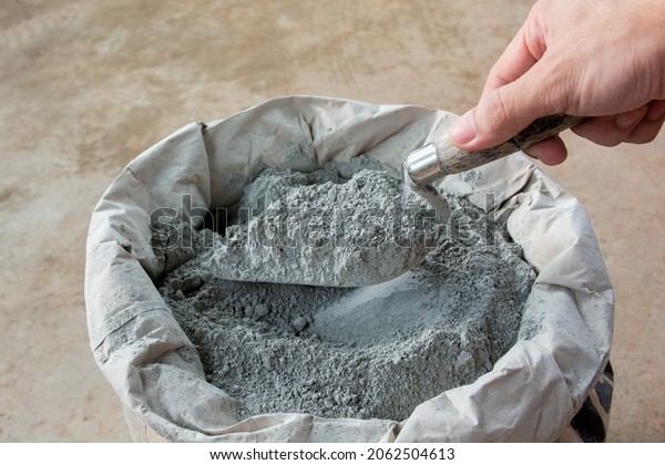 Cement powder\
with trowel put in bag\
package\
