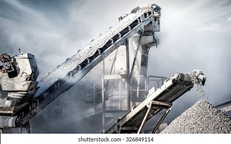 Cement production factory on mining quarry. Conveyor belt of heavy machinery loads stones and gravel 